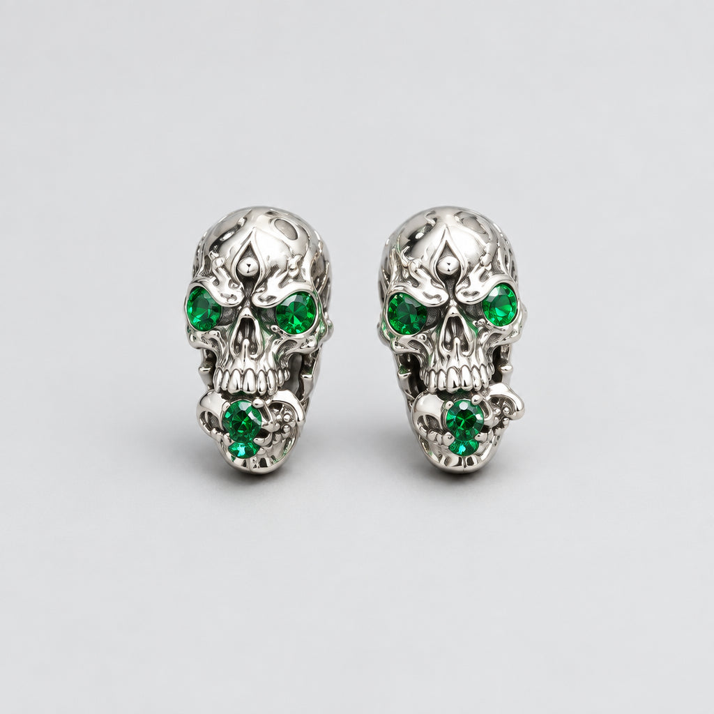 Gothic Skull Stud Earrings, Carved Flame Pattern, Emerald Green Gem Eyes, Ornate Metal Detailing, Dark Occult Statement Earrings